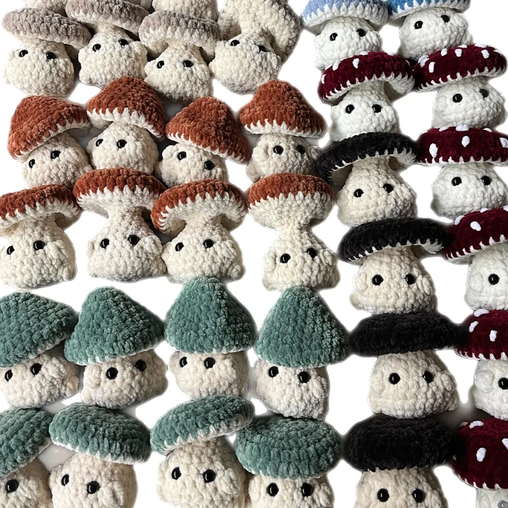 Multiple handmade crochet mushrooms in different colors