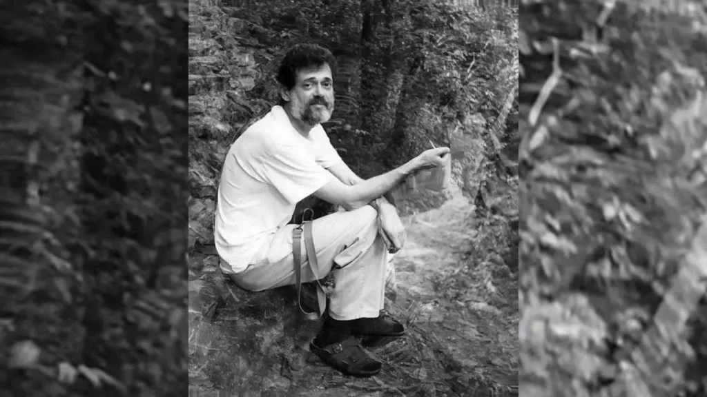 an image from the terence mckenna archive of tm sitting under a tree in a white t shirt
